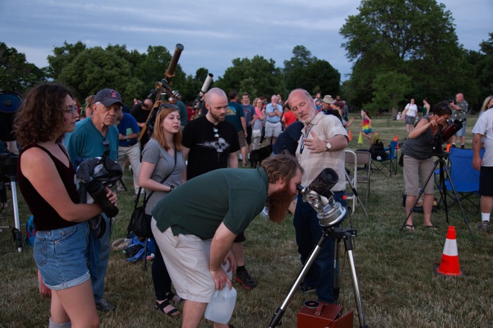 Photo: Jay Reynolds, gesturing as attendees view Jupiter, coordinated CAA's participation in the Celebration. Photo by James Guilford.